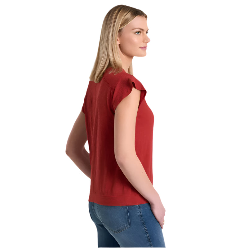 Woman wearing a red sleeveless top and blue jeans on a white background