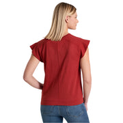 Woman wearing a red top and blue jeans on a white background