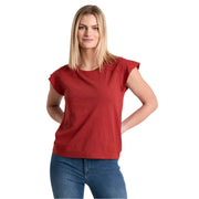 Woman wearing a red shirt and blue jeans on a white background
