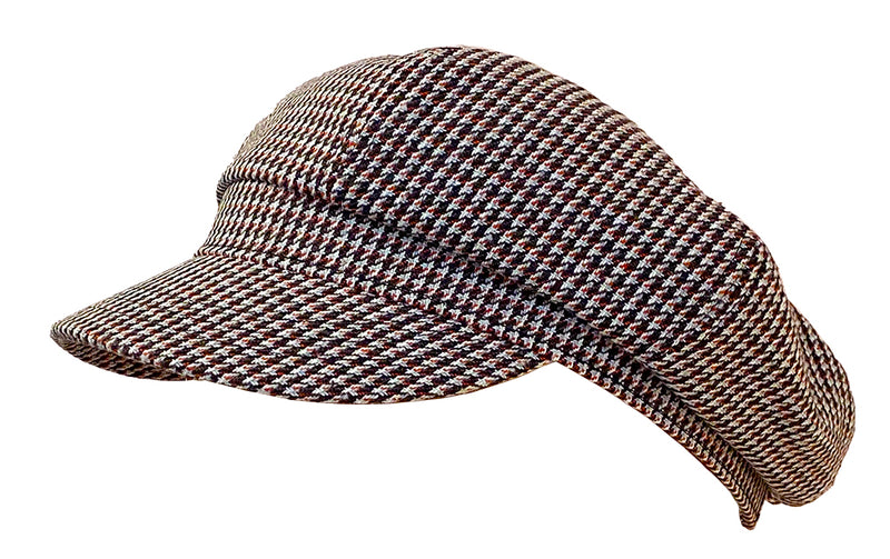 Side view of a black and white houndstooth patterned cabby cap against a white background.