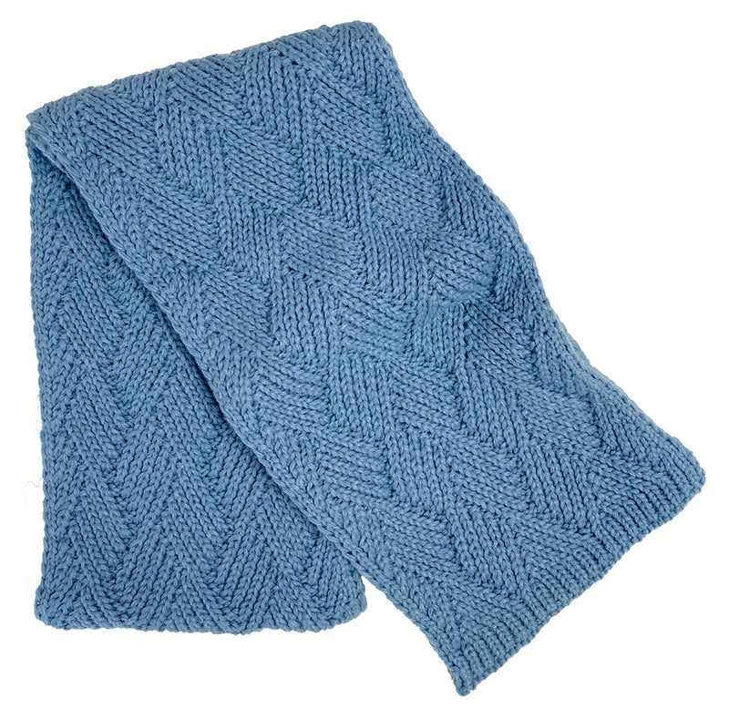 Light blue knit scarf against a white background. 
