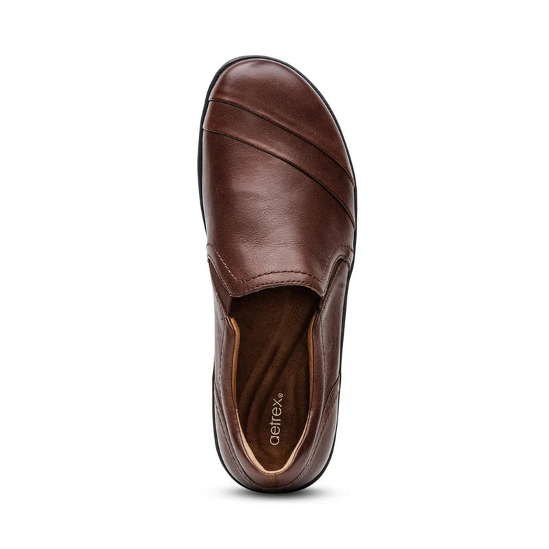 Brown leather shoe on a white background.