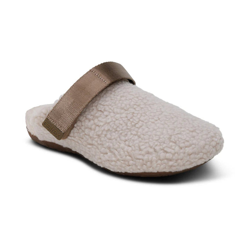 Fur slipper with brown strap on a white background.