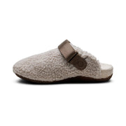 Fur slipper with brown strap on a white background.