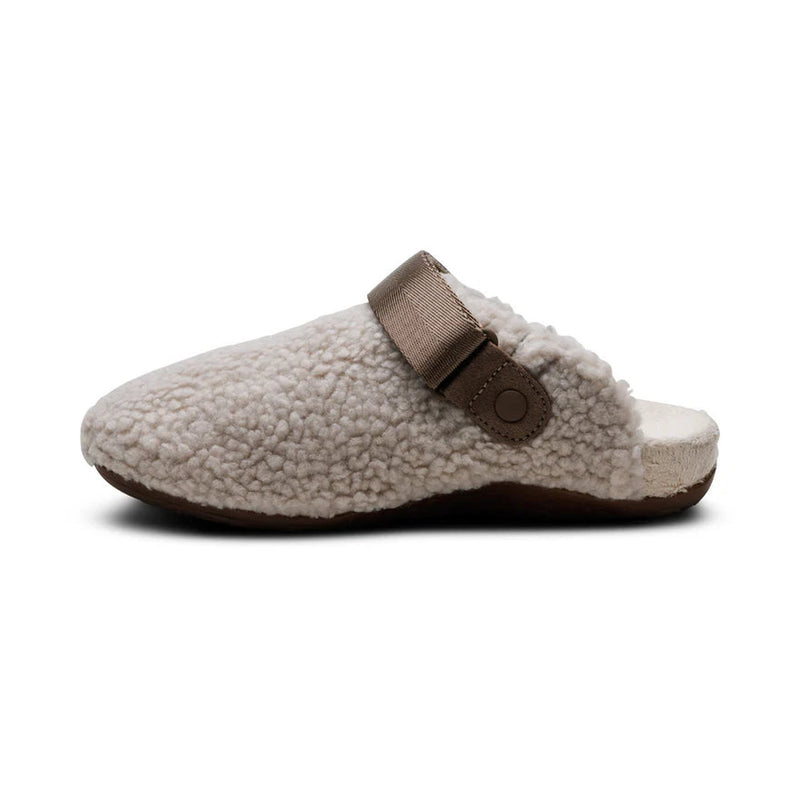 Fur slipper with brown strap on a white background.