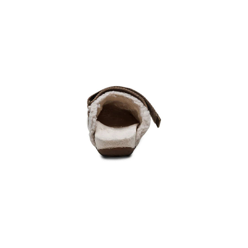 Back view of a fur sandal with brown strap on a white background.