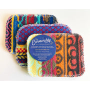 Three Euroscrubby multi-purpose cleaning sponges with colorful geometric patterns, arranged in a fan shape with a blue brand label on top, on a white background.