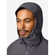A man wearing a dark gray hooded rain jacket, shown from the chest up against a light gray background.