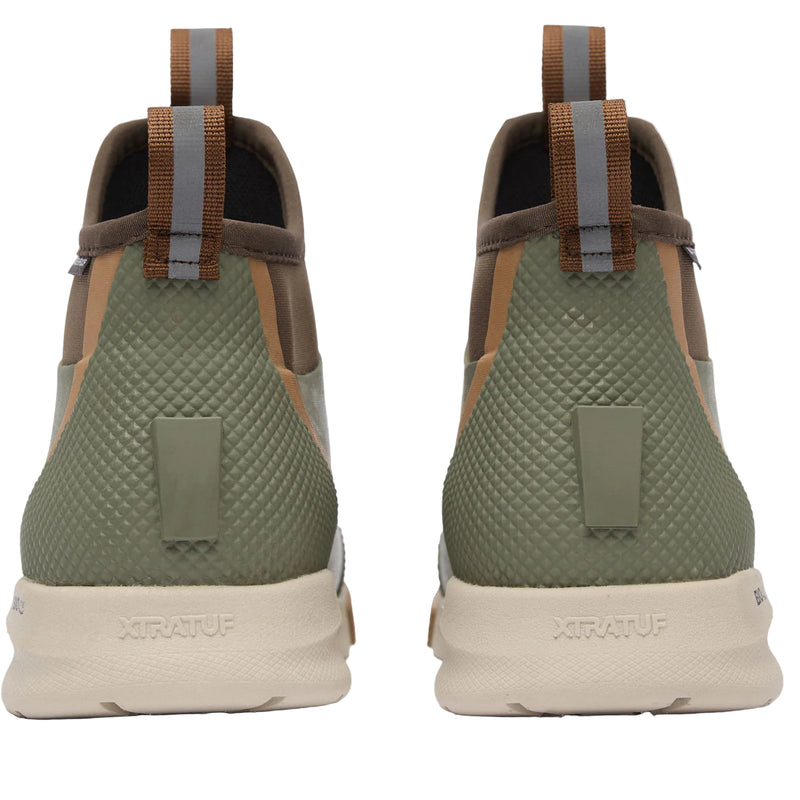 Green and brown shoes with Xtratuf branding on a white background