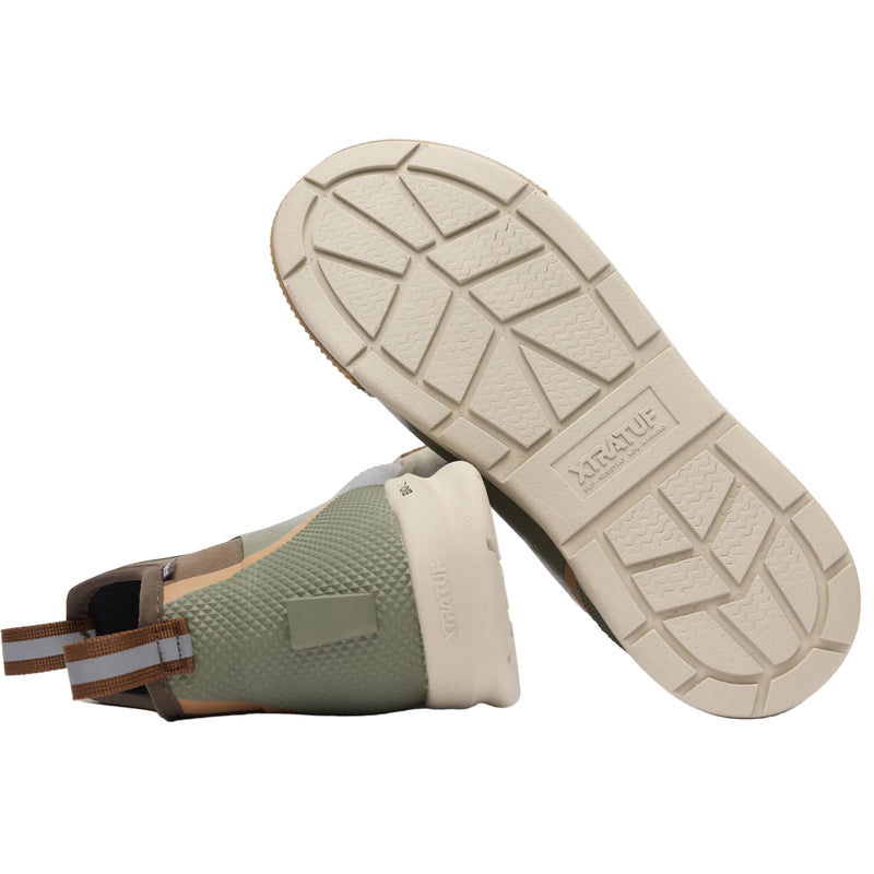 Green boot with beige sole on a white background