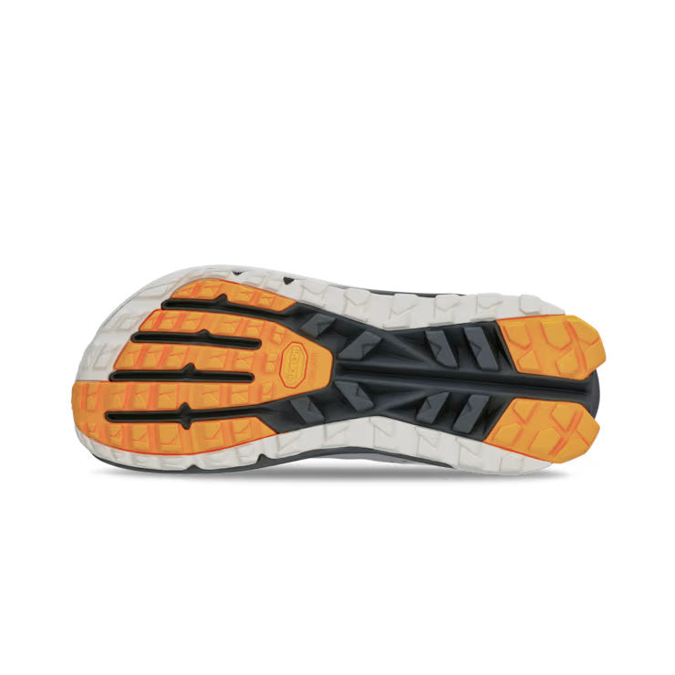 Bottom view of a hiking shoe with a black, white, and orange tread against a white background. 