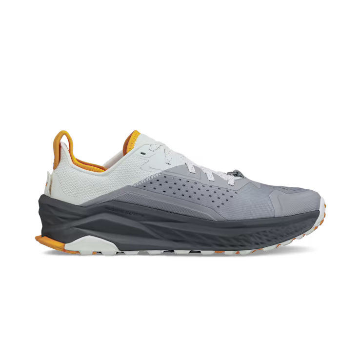 Side view of a gray hiking shoe with white and orange accents against a white background. 