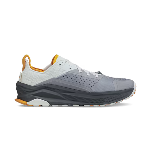 Side view of a gray hiking shoe with white and orange accents against a white background. 
