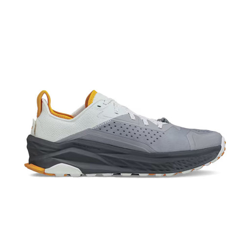 Side view of a gray hiking shoe with white and orange accents against a white background. 