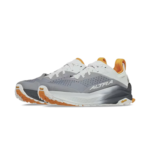 Side view of a pair of gray hiking shoes with orange and white accents against a white background. 