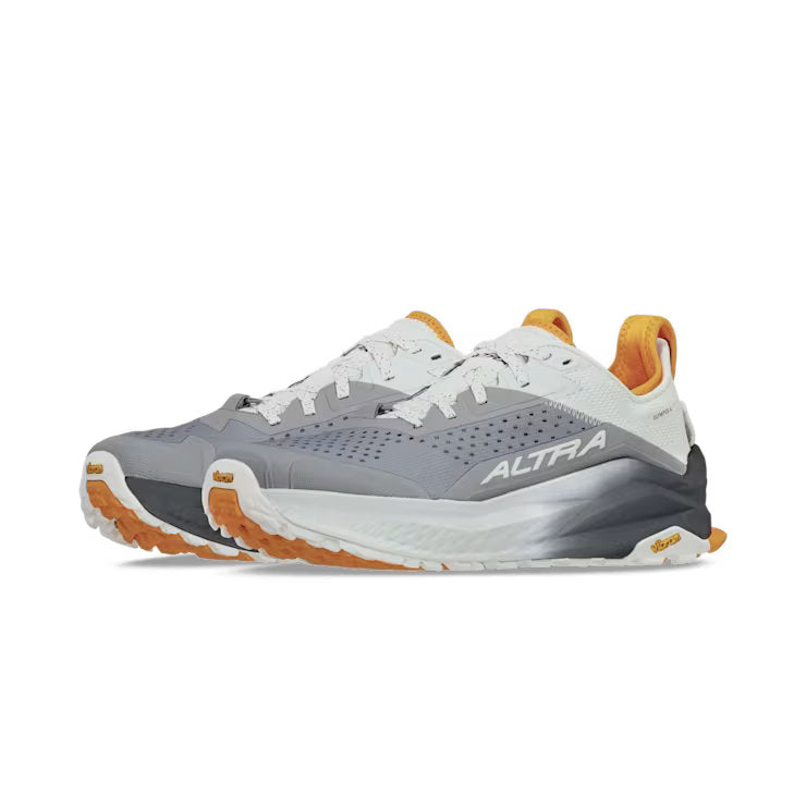 Side view of a pair of gray hiking shoes with orange and white accents against a white background. 