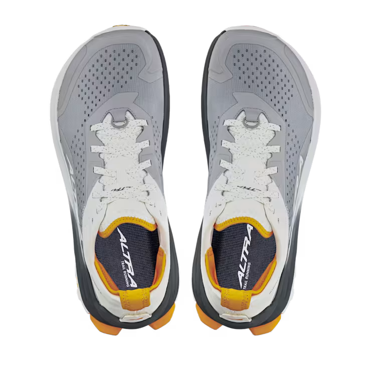 Top view of a pair of grey hiking shoes with white and orange accents against a white background. 