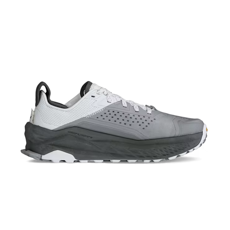Side view of a gray and white hiking shoe against a white background. 