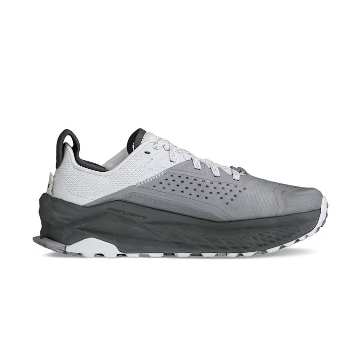 Side view of a gray and white hiking shoe against a white background. 