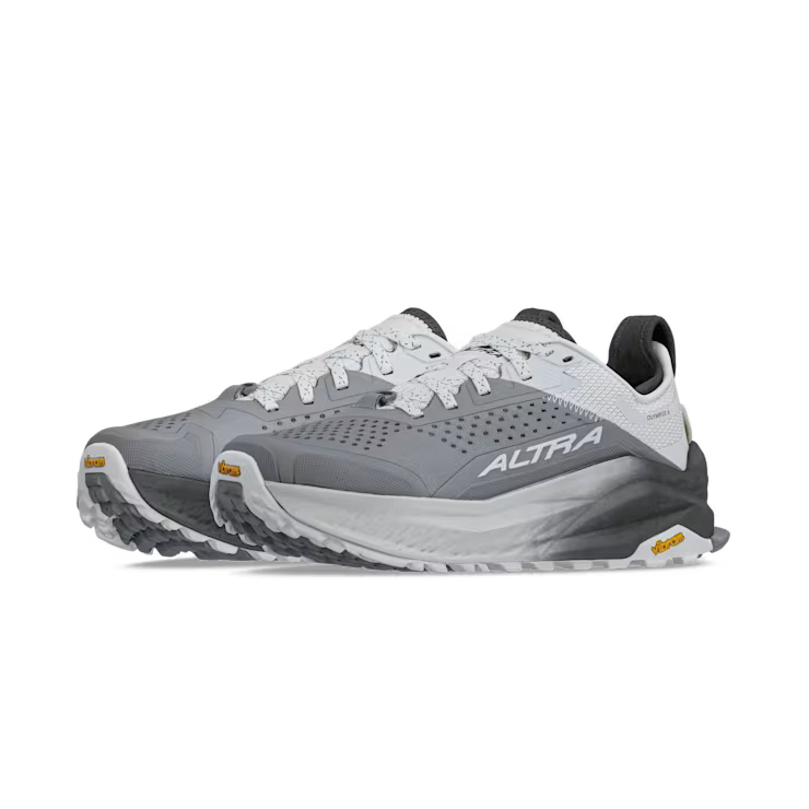 Side view of a pair of gray and white hiking shoes against a white background.
