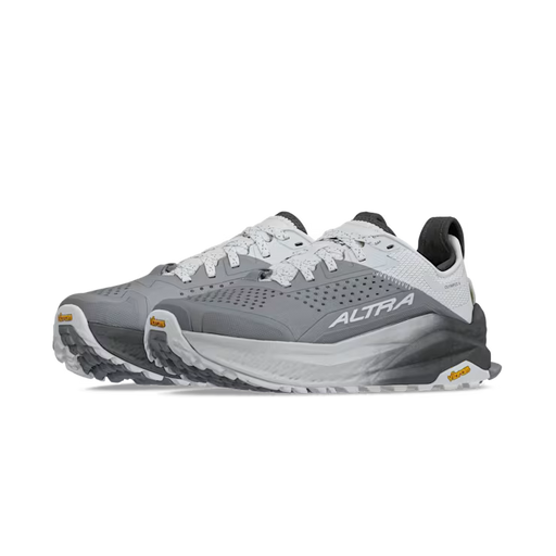 Side view of a pair of gray and white hiking shoes against a white background.