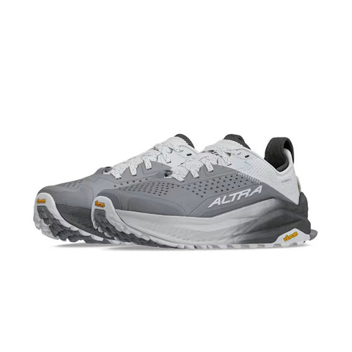 Side view of a pair of gray and white hiking shoes against a white background.