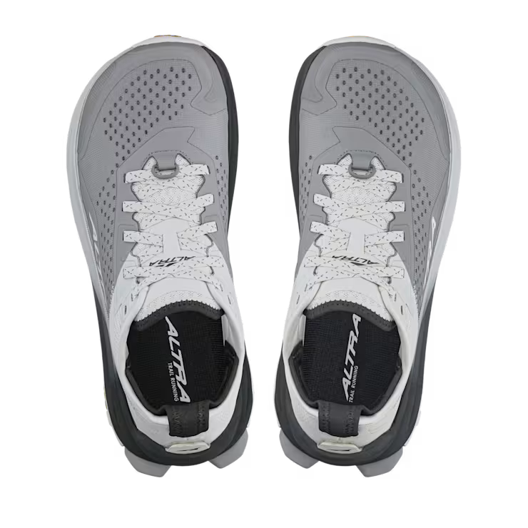 Top view of a pair of white and gray hiking shoes against a white background. 
