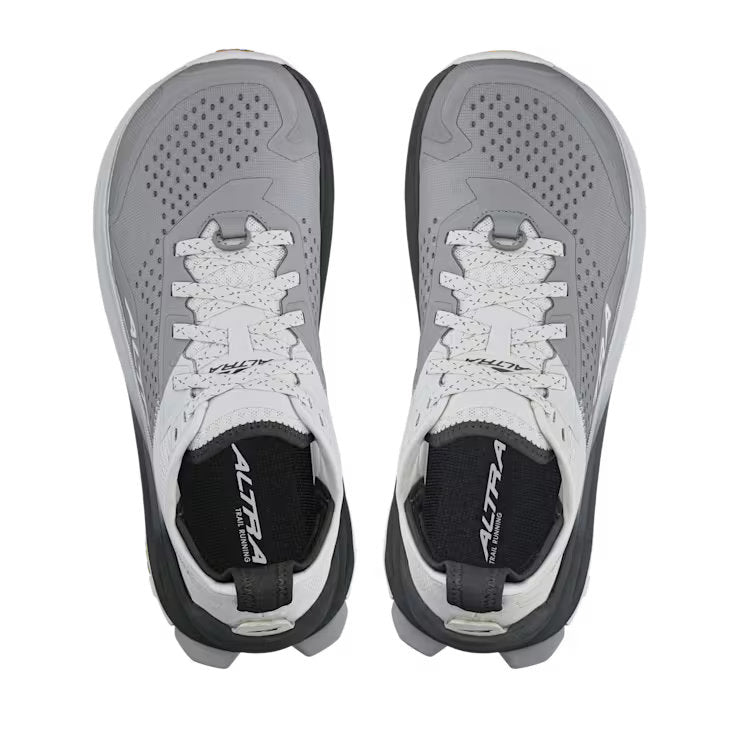 Top view of a pair of white and gray hiking shoes against a white background. 