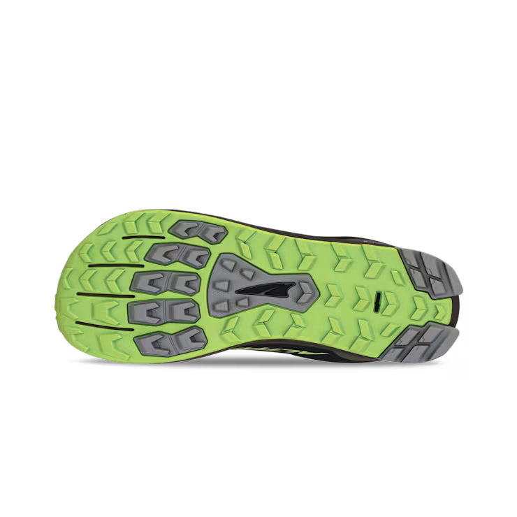 Bottom view of a black shoe. The tread has a lime green and grey color against a white background. 