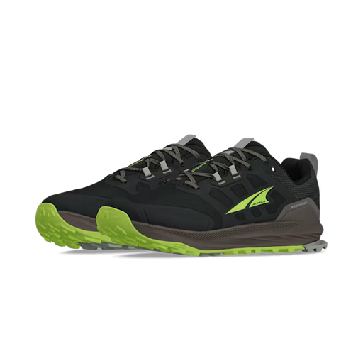 Side view of a pair of black hiking shoes with lime green accents against a white background. 