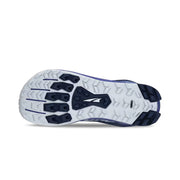 Bottom view of a blue hiking shoe showing a white and darker blue colored tread against a white background. 