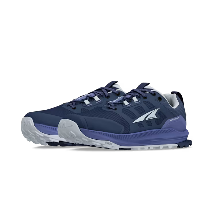 Side view of a pair of dark blue hiking shoes with .ight blue accents against a white background. 