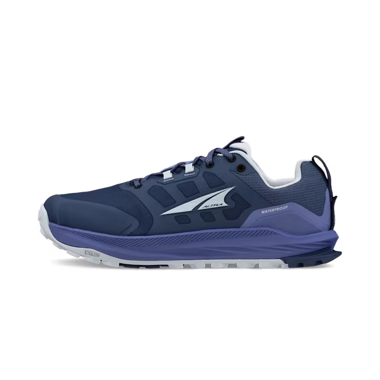 Side view of a dark blue hiking shoe with light blue accents against a white background. 
