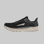 A black running shoe with a white bottom on a white background