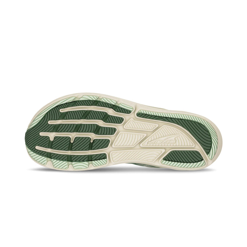 The bottom of a green running shoe on a white background