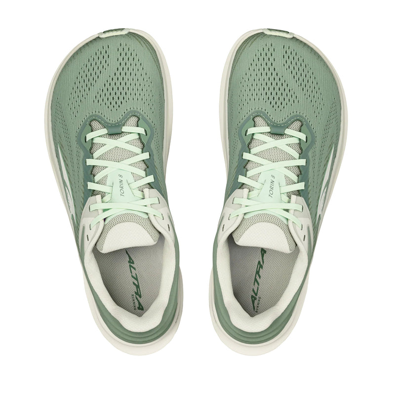 A pair of green running shoes with white details on a white background