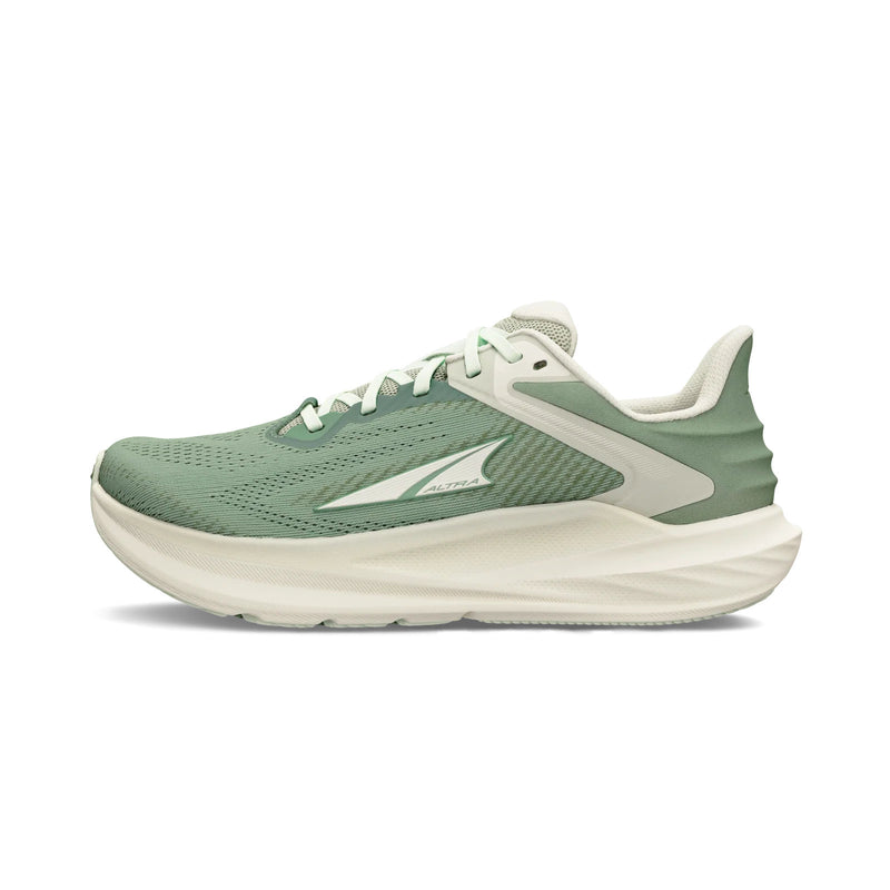 A green running shoe with white details on a white background