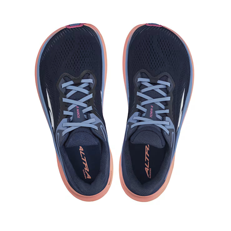 Top view of a pair of navy blue trail running shoes with pink accents and blue laces against a white background. 