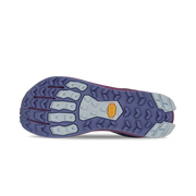 Bottom view of a navy and purple colored trail running shoe. The tread has a dark blue and light blue color to it against a white background. 