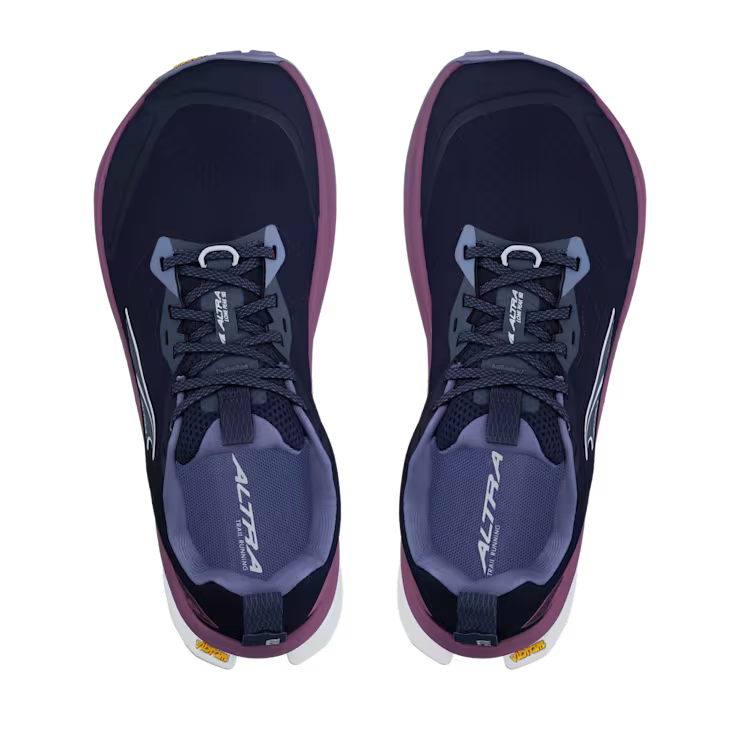 Top view of a pair of navy blue colored shoes with purple accents against a white background. 