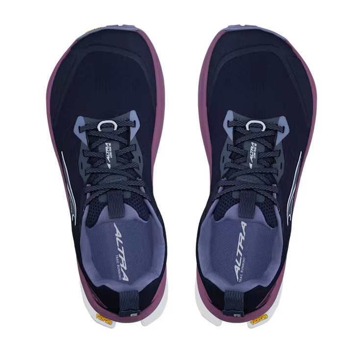 Top view of a pair of navy blue colored shoes with purple accents against a white background. 