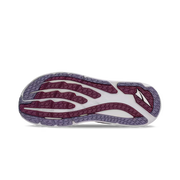 Bottom view of a trail running shoe. The tread has white, white, and gray accents and it sits against a white background. 