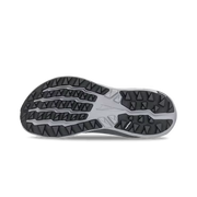 View of the bottom tread of a grey trail running shoe against a white background. 