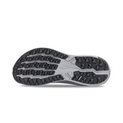 View of the bottom tread of a grey trail running shoe against a white background. 