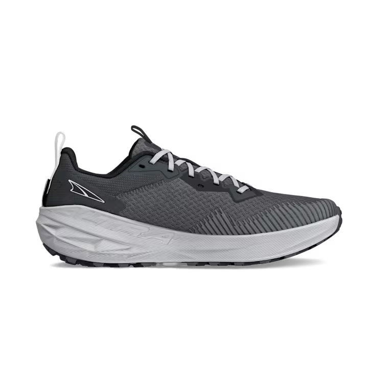 Side view of a gray trail running shoe with white laces against a white background. 