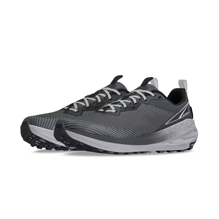 Side view of a pair of gray trail running shoes with white laces against a white background. 