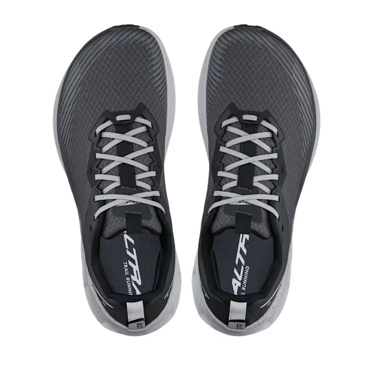 Top view of a pair of gray trail running shoes with white laces against a white background. 