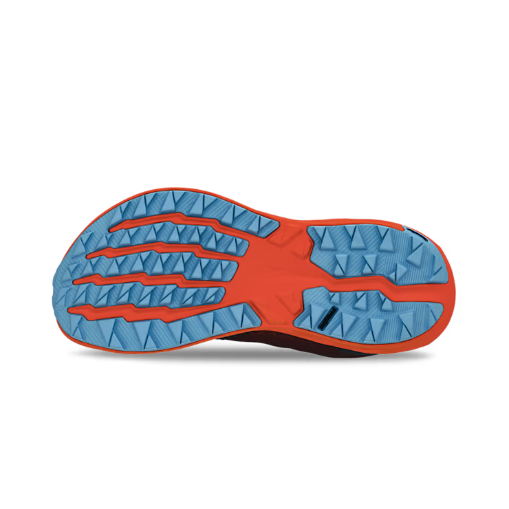 View of the bottom tread of a red and orange trail running shoe against a white background. 