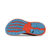 View of the bottom tread of a red and orange trail running shoe against a white background. 