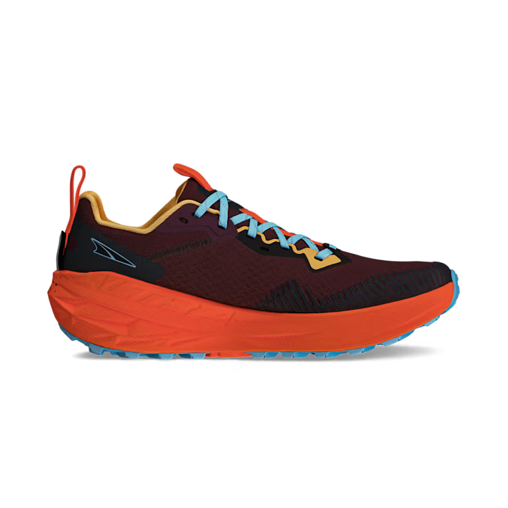 Side view of a red trail running shoe with orange accents against a white background. 